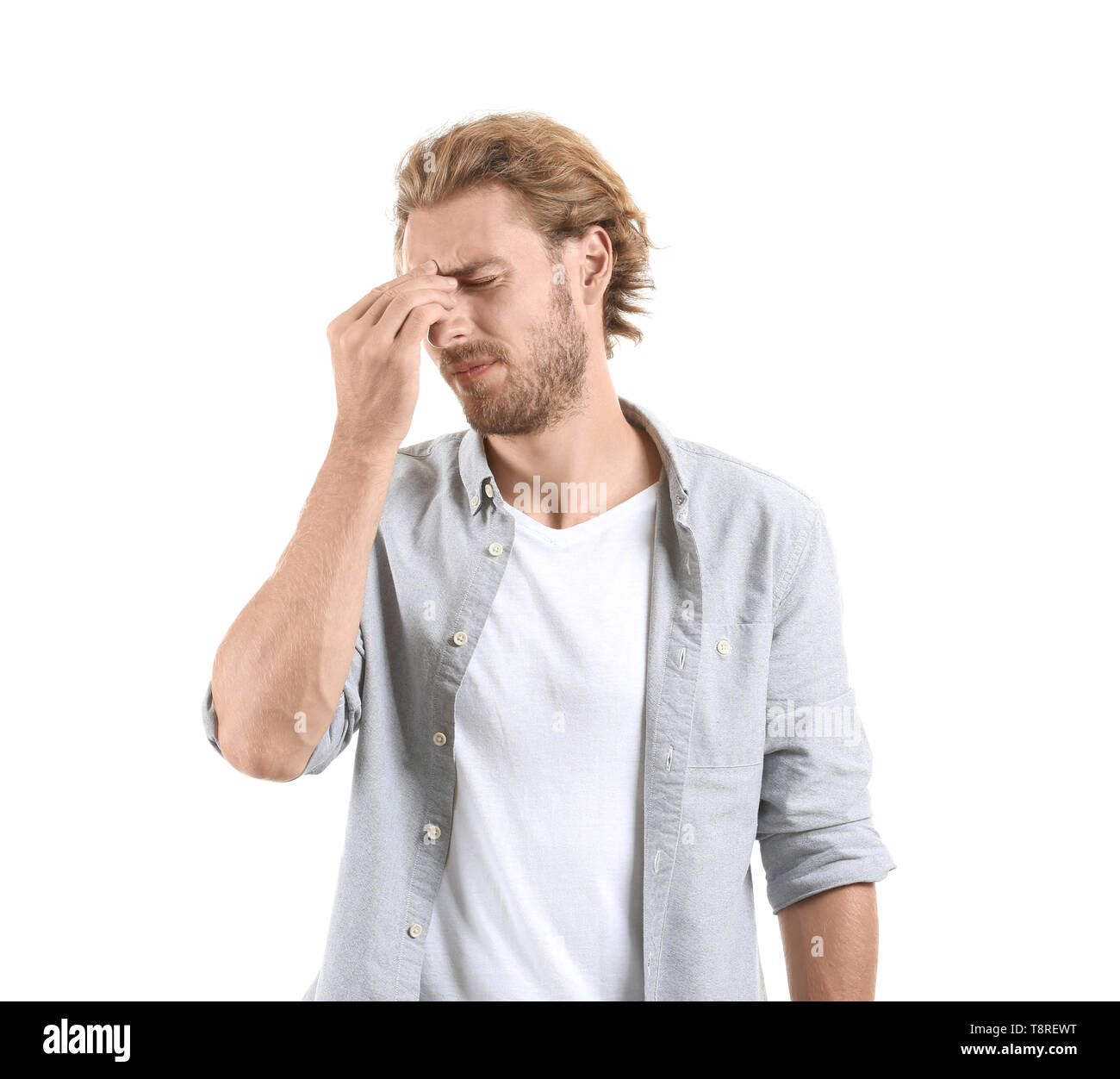 Portrait of man suffering from headache on white background Stock Photo ...