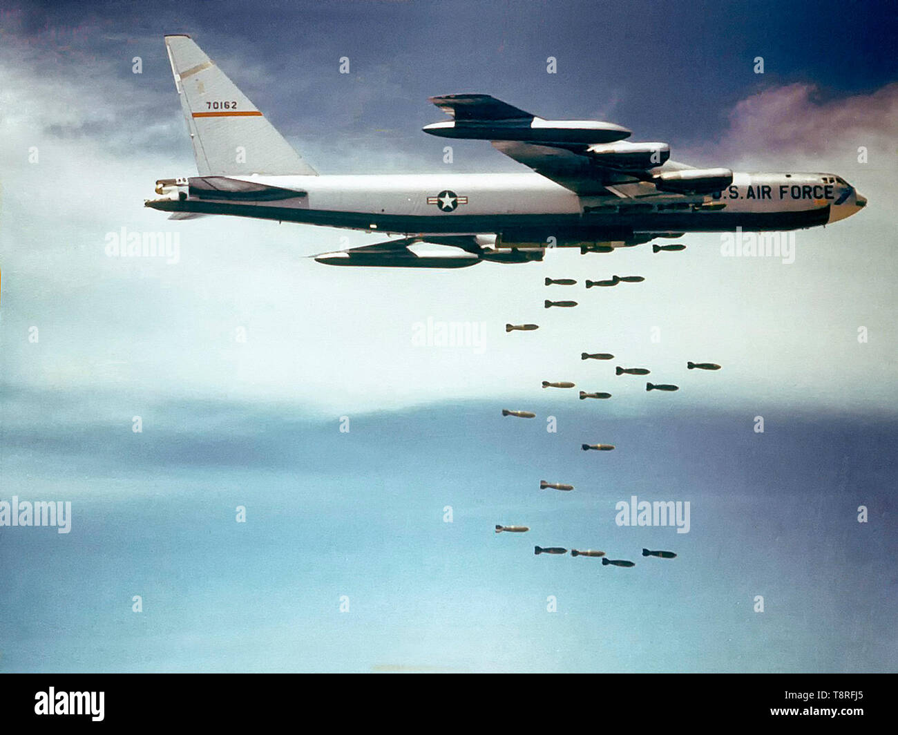 A U.S. Air Force Boeing B-52F-70-BW Stratofortress (s/n 57-0162, nicknamed 'Casper The Friendly Ghost') from the 320th Bomb Wing dropping Mk 117 750 lb (340 kg) bombs over Vietnam. Stock Photo