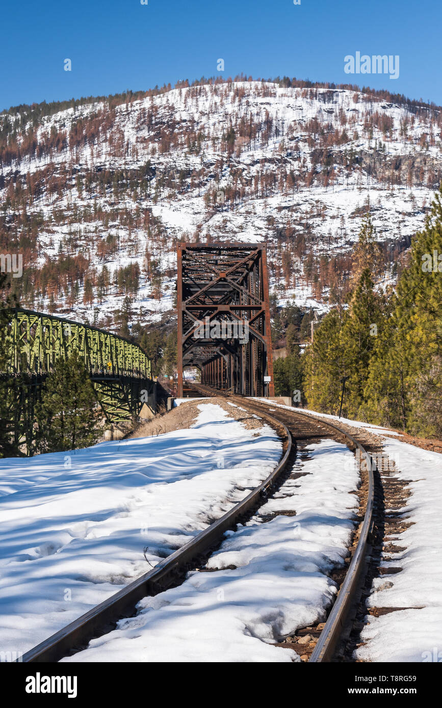 State Highway 20, US Highway 395 and the railroad cross Lake Roosevelt at Kettle Falls, Washington on Steel Truss Bridges in the early spring Stock Photo