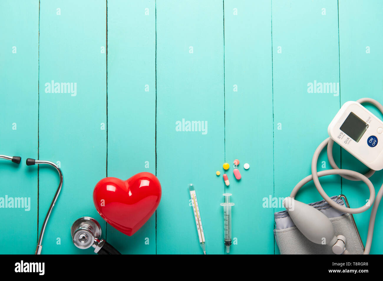 Top view of stethoscopes, Plastic red heart, Automatic portable blood