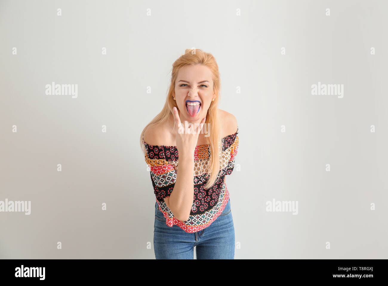 Portrait of funny naughty woman with unusual lipstick on white background Stock Photo