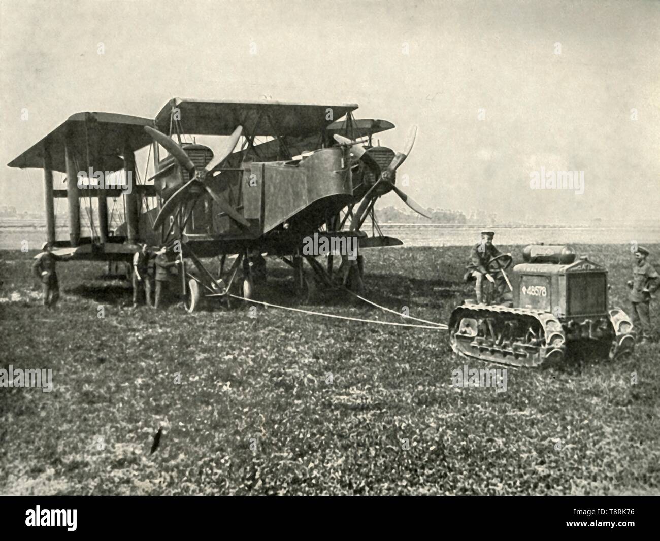 'A Small Motor Tractor Getting a Huge R.A.F. Bombing Machine into Position...', (1919).  Creator: Unknown. Stock Photo