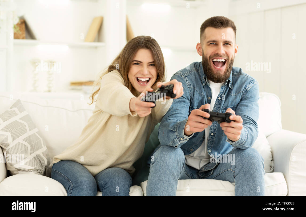 Crazy Couple Enjoying Playing Videogame On Playstation Stock Photo - Alamy