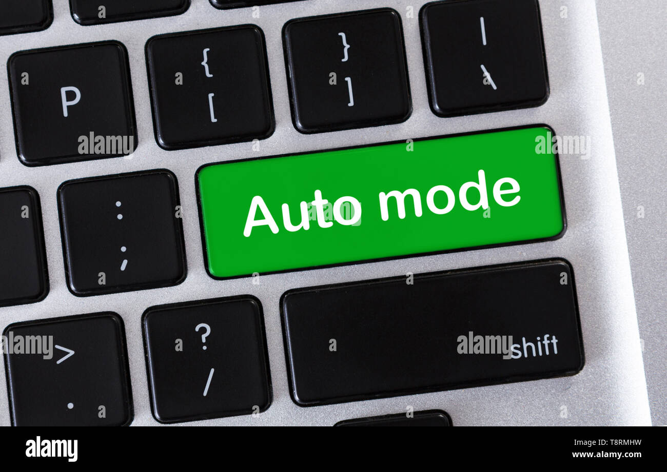Green laptop button with text Auto mode Stock Photo