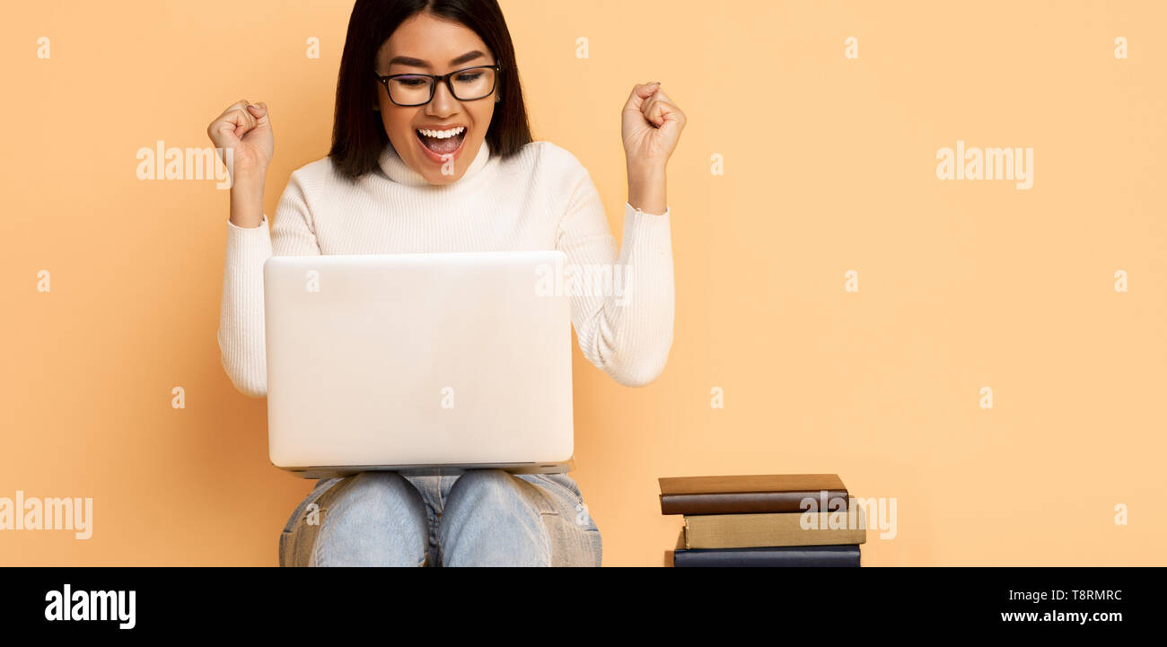 Yeah, I Passed Exam! Happy Student Girl With Books And Laptop Stock Photo