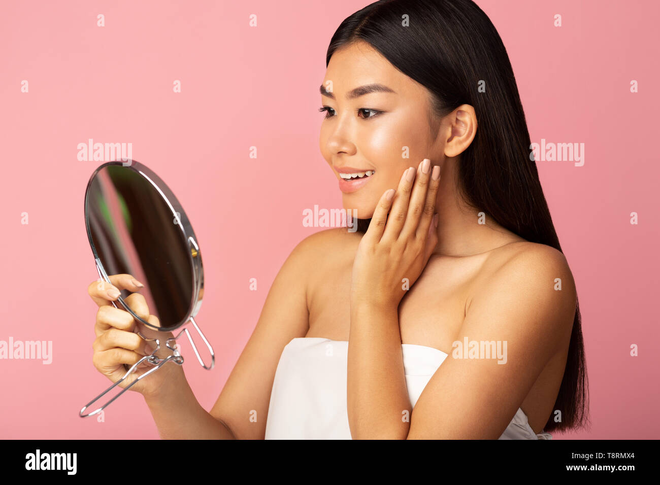 Skin Care Concept. Young Asian Girl Looking In Mirror Stock Photo