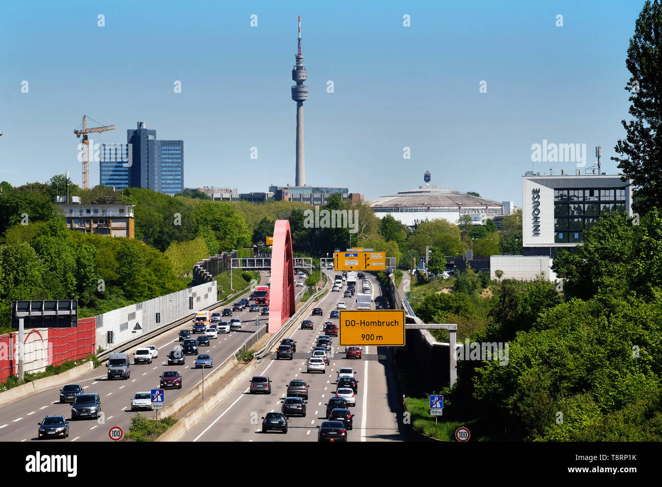 Skyline of Dortmund, with motorway A40 (Ruhrschnellweg) in Dortmund as federal highway No. 1 with football arena Westfalenstadion (Signal Iduna Park), Westfalenhalle and TV tower Florianturm in Westfalenpark. Stock Photo
