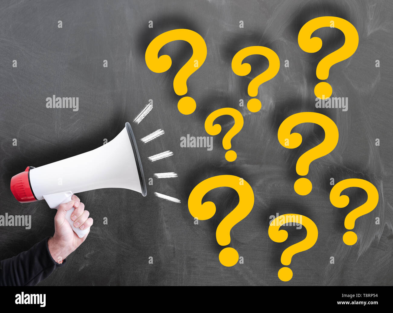 shouting out questions using a megaphone against chalkboard Stock Photo