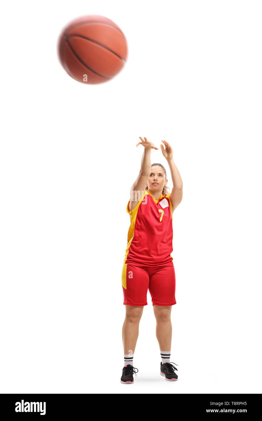 Full length portrait of a female player shooting a basketball isolated