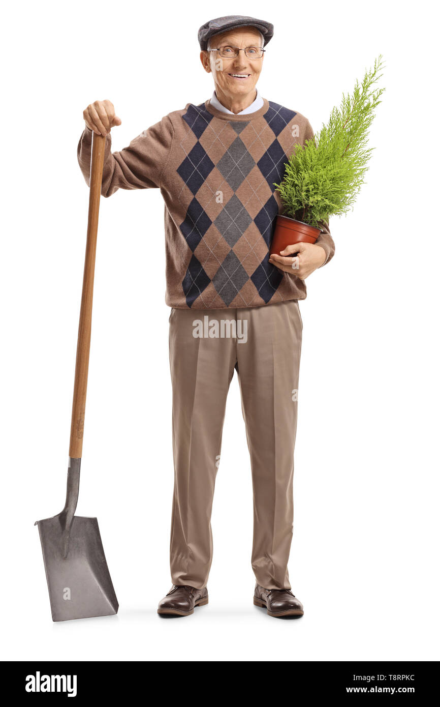 Full length portrait of a senior man standing with a shovel and a plant ...