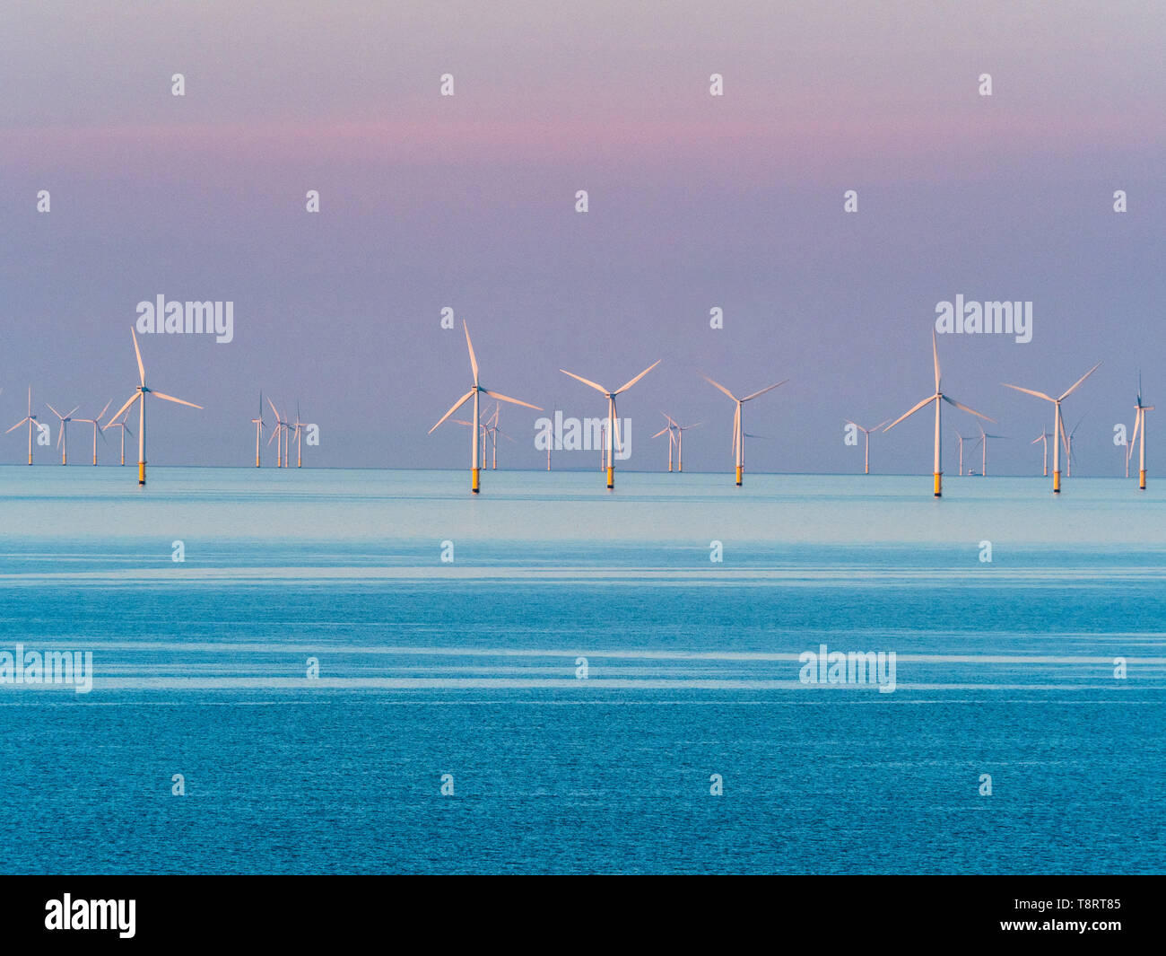 Wind Turbines off the North Wales seaside resort of Llandudno at dusk. Gwynt y Môr wind farm. Stock Photo