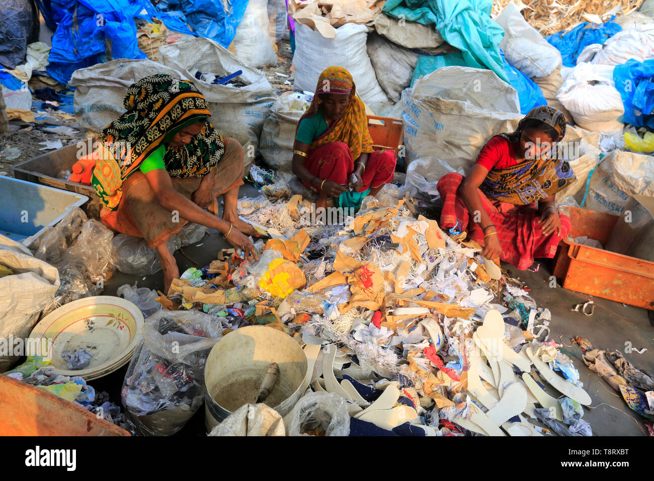 Women are looking for usable items among the plastic waste at Tongi in Gazipur. Bangladesh. Stock Photo