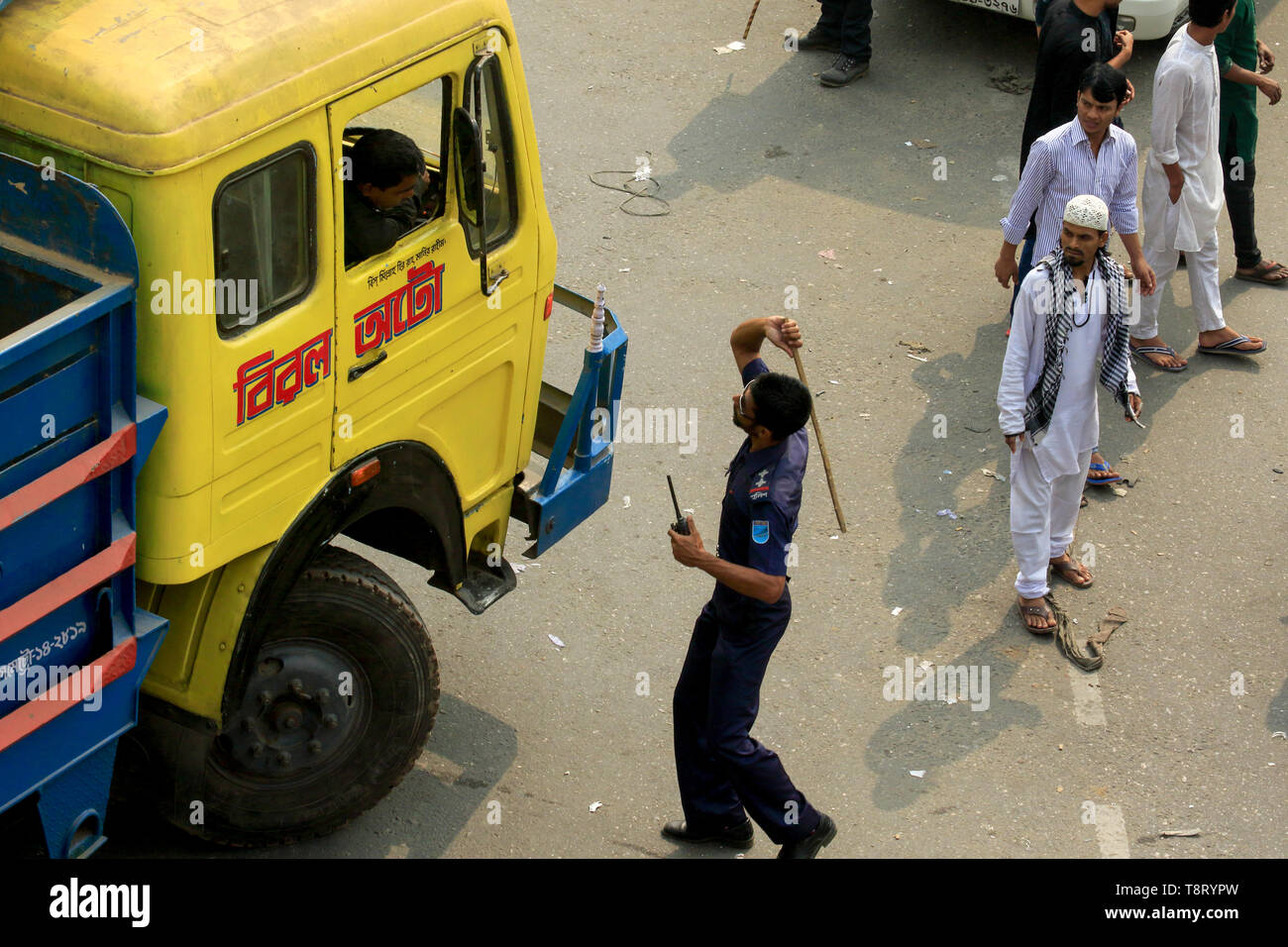 An unlawful baton charge to a truck driver by a police on the Road at Tongi in Gazipur. Bangladesh Stock Photo