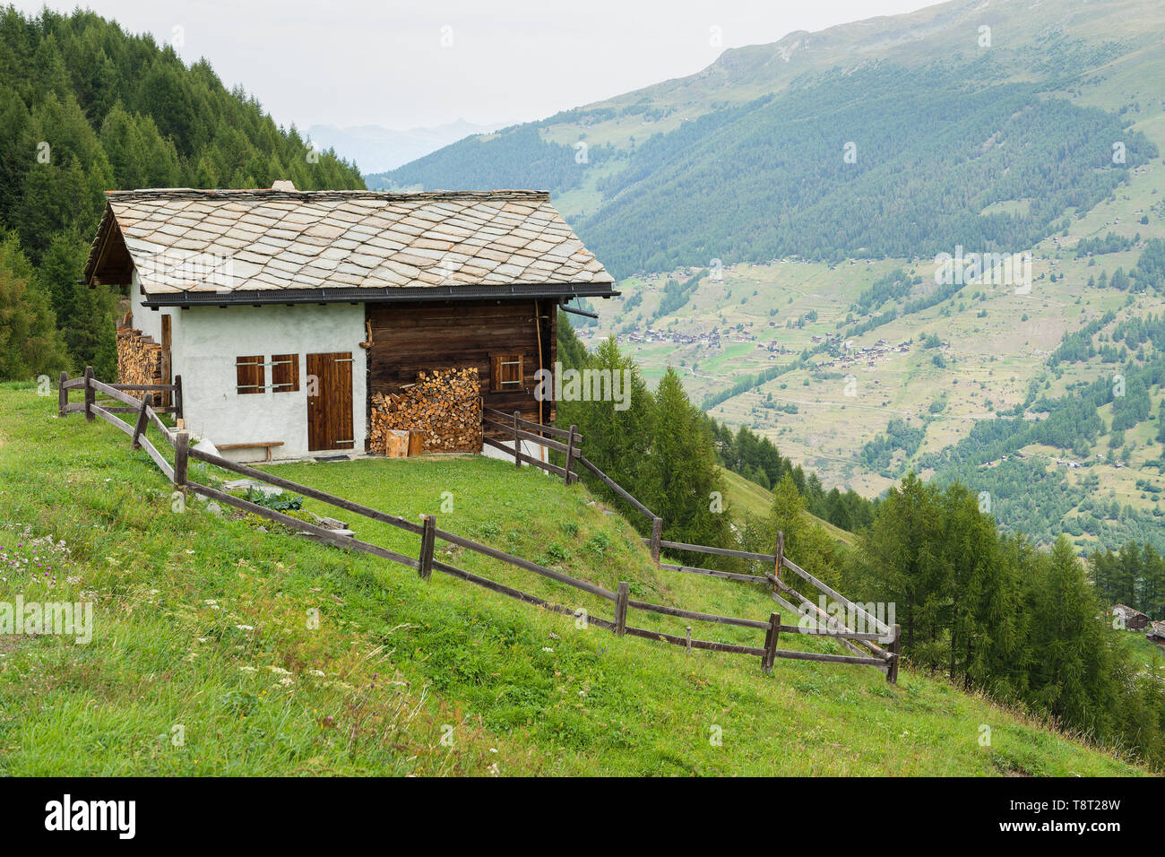 Pretty typical Swiss house in Swiss Alps with mountains Stock Photo Alamy