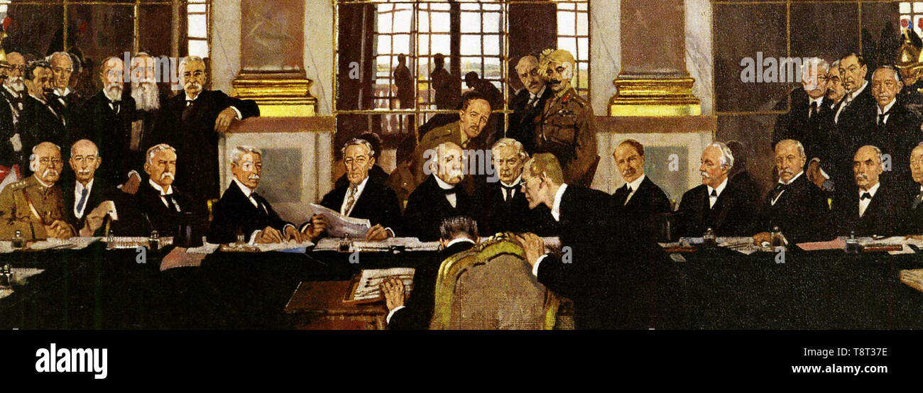 Treaty of Versailles. German Johannes Bell signs the Treaty of Versailles in the Hall of Mirrors, with various Allied delegations sitting and standing in front of him. Stock Photo