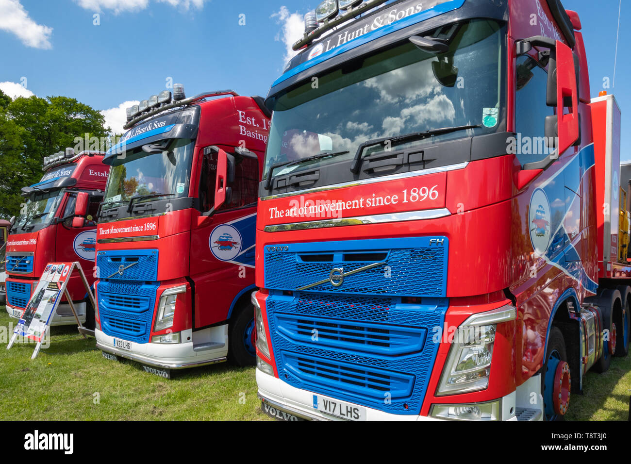 Three red lorries or trucks owned by L. Hunt & sons ltd haulage on display at the Basingstoke Transport Festival Stock Photo