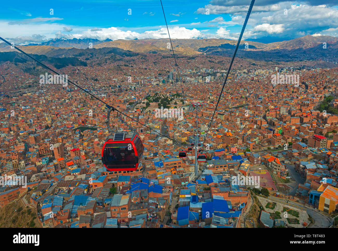 Cityscape of La Paz city and the new public transport system of Cable Cars named Teleferico, the snowcapped Andes mountain peaks in the back, Bolivia. Stock Photo