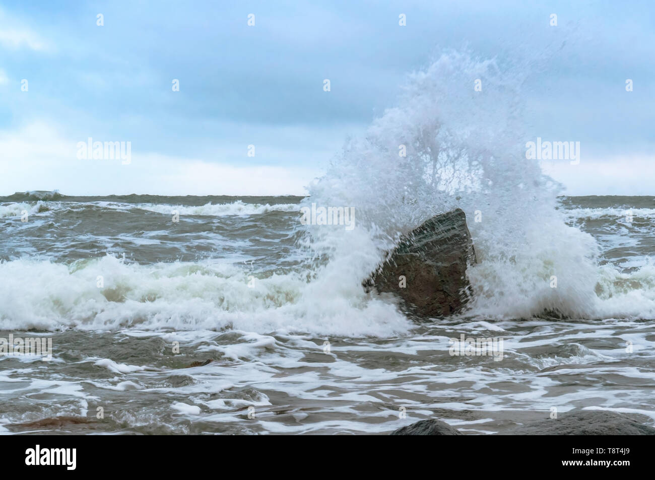 sea wave beats on a stone, stormy weather by the sea Stock Photo