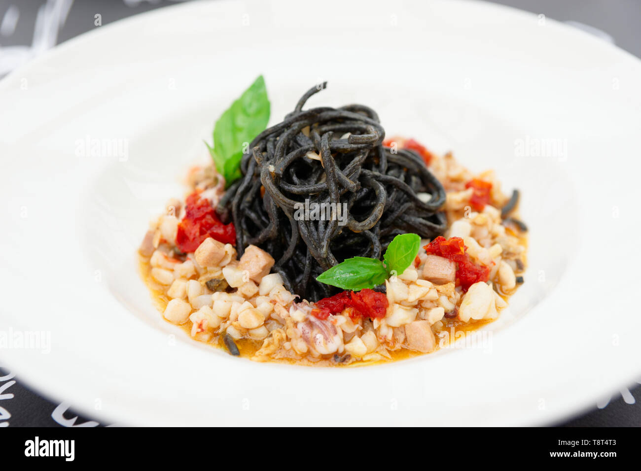 Black squid ink pasta with seafood, close-up Stock Photo