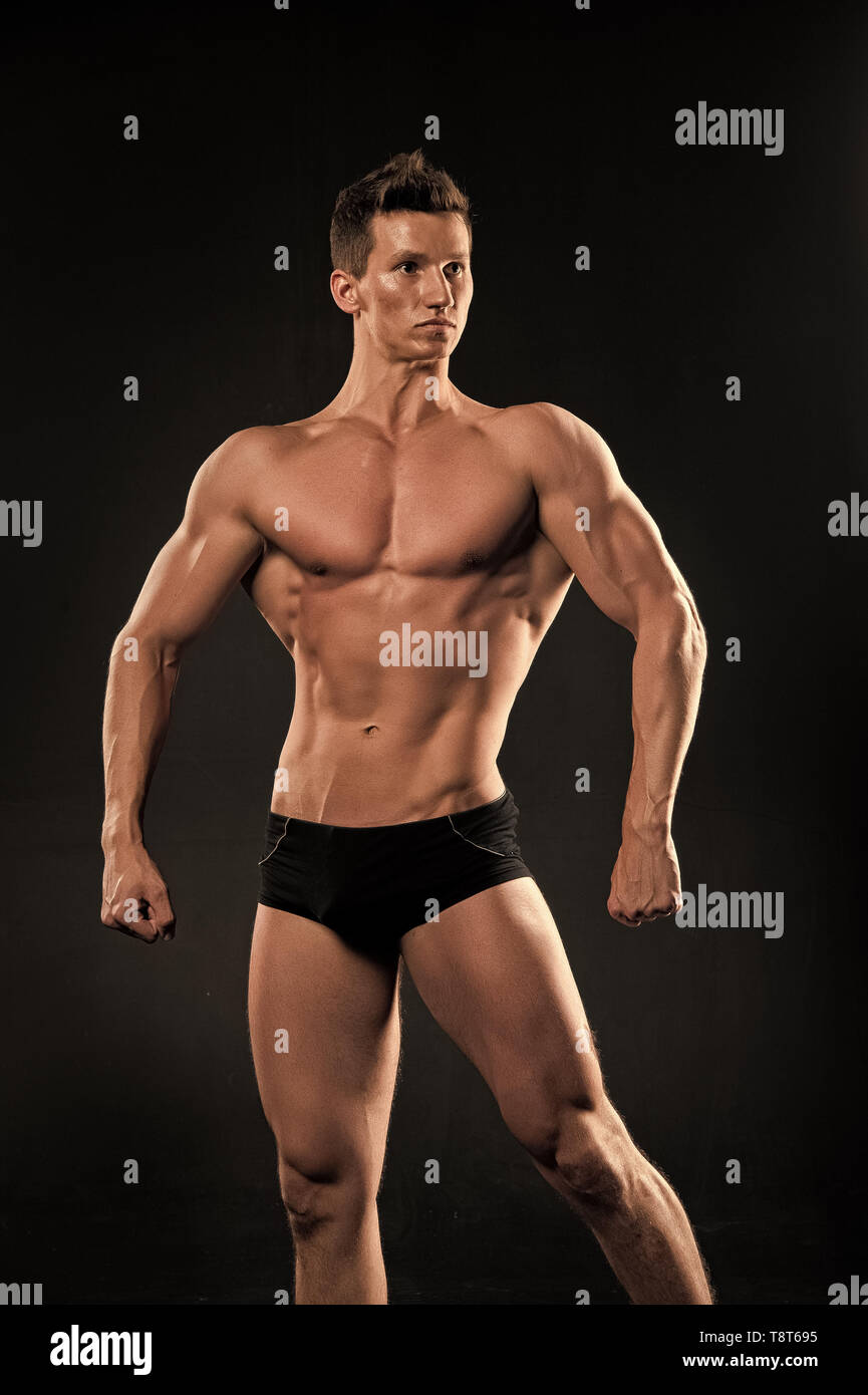 Man athlete show muscular body on dark background. Bodybuilder with bare  torso, six pack, ab, biceps, triceps, muscles. Sport, bodybuilding,  fitness. Healthy lifestyle concept dieting Stock Photo - Alamy