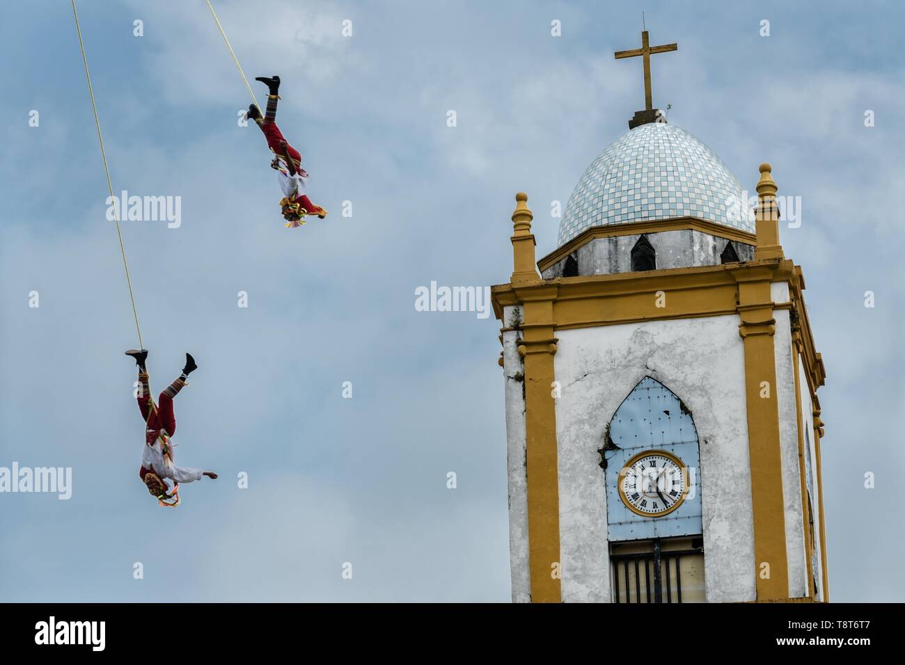 Voladores performs in front of the Church of the Assumption in Papantla,  Veracruz, Mexico. The Danza de los Voladores is a indigenous Totonac  ceremony involving five participants who climb a thirty-meter pole.