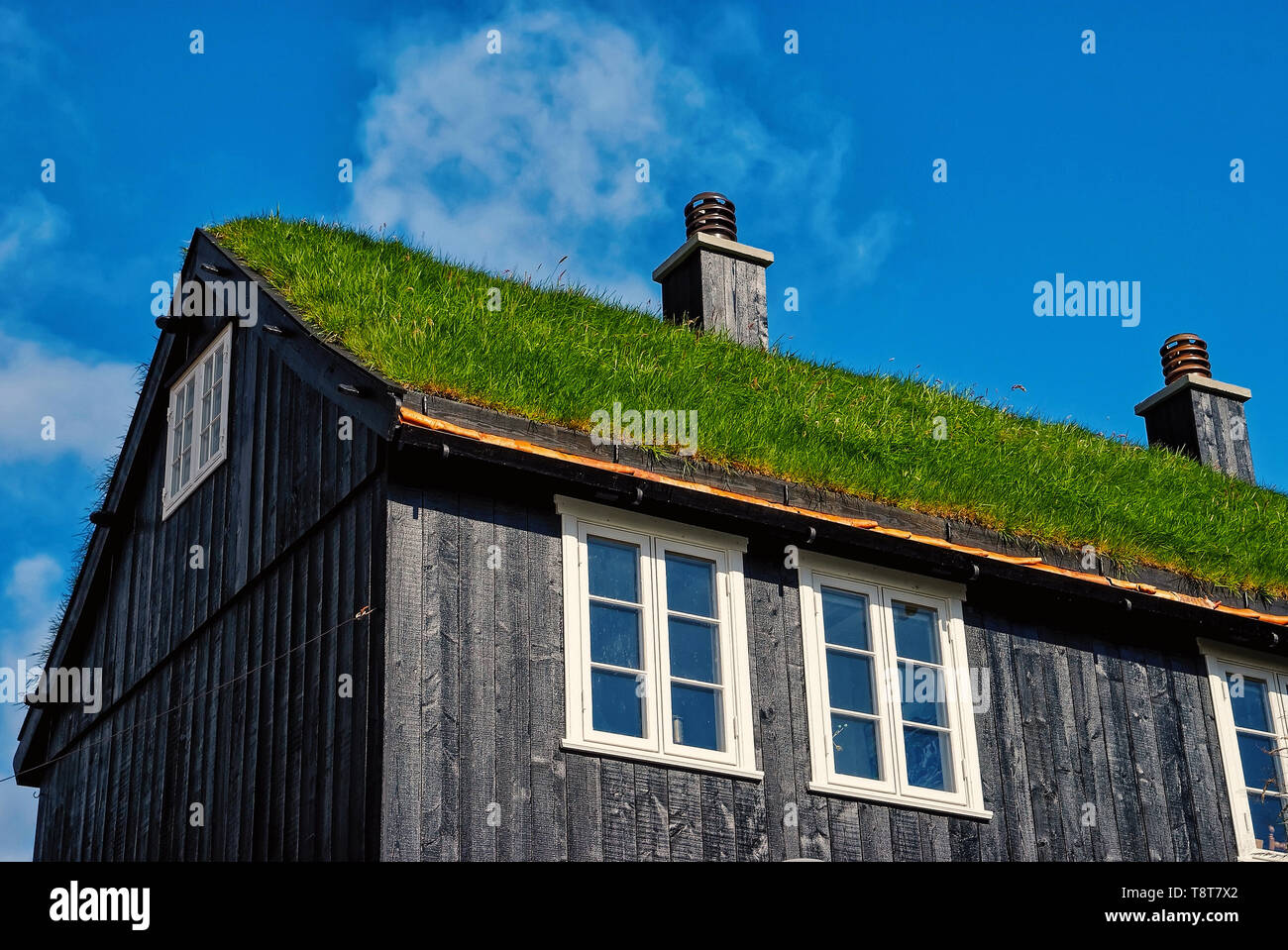 House with grass roof in Torshavn, Denmark. Eco friendly building. Architecture and design. Destination place. Ecology and environment. Summer vacation in countryside. Stock Photo