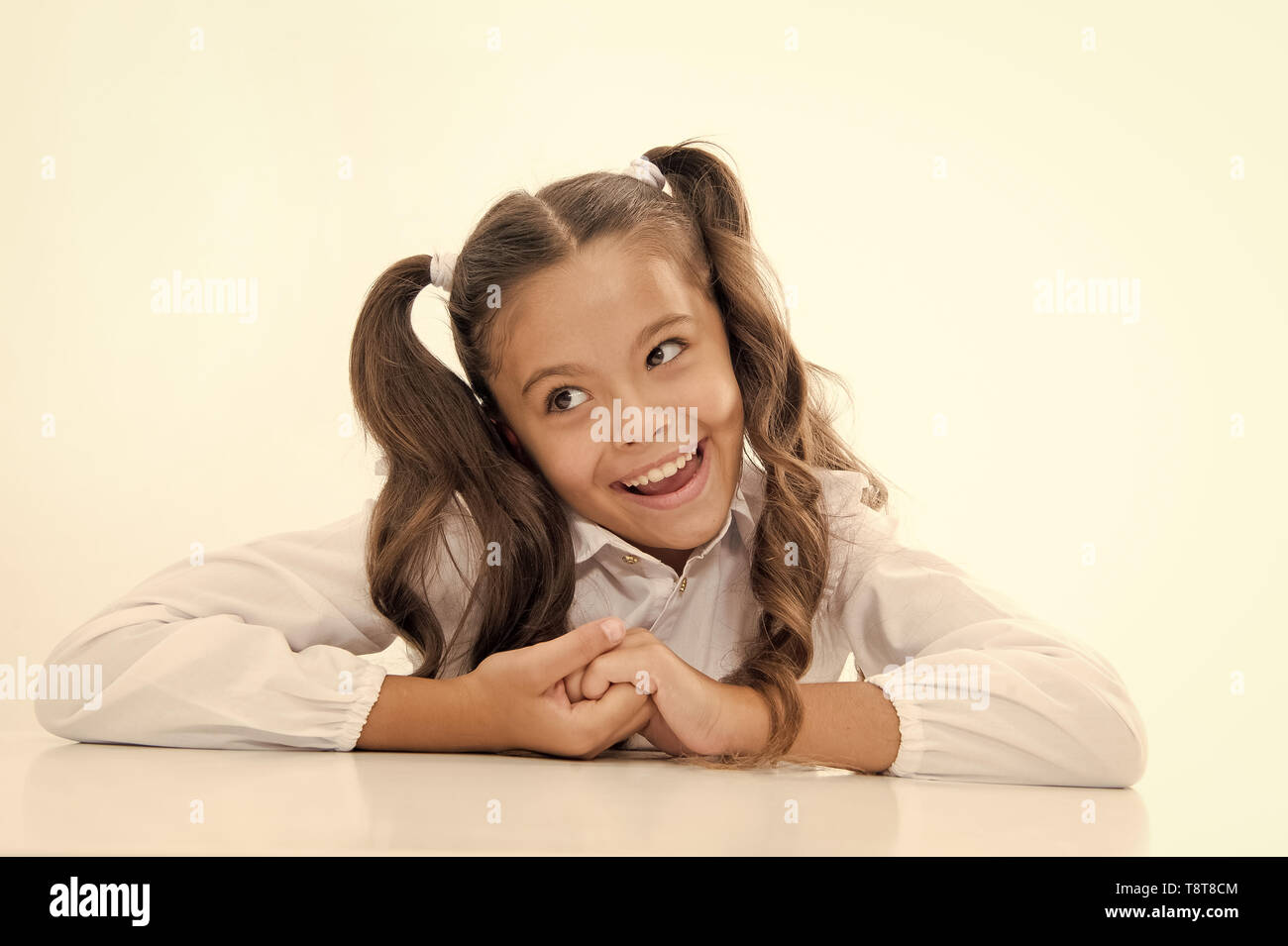 Perfect schoolgirl with tidy fancy hair. School hairstyle ultimate top  list. Prepare kid first school day. Schoolgirl happy carefree face cute  ponytail. Excellent pupil lean on desk isolated white Stock Photo -