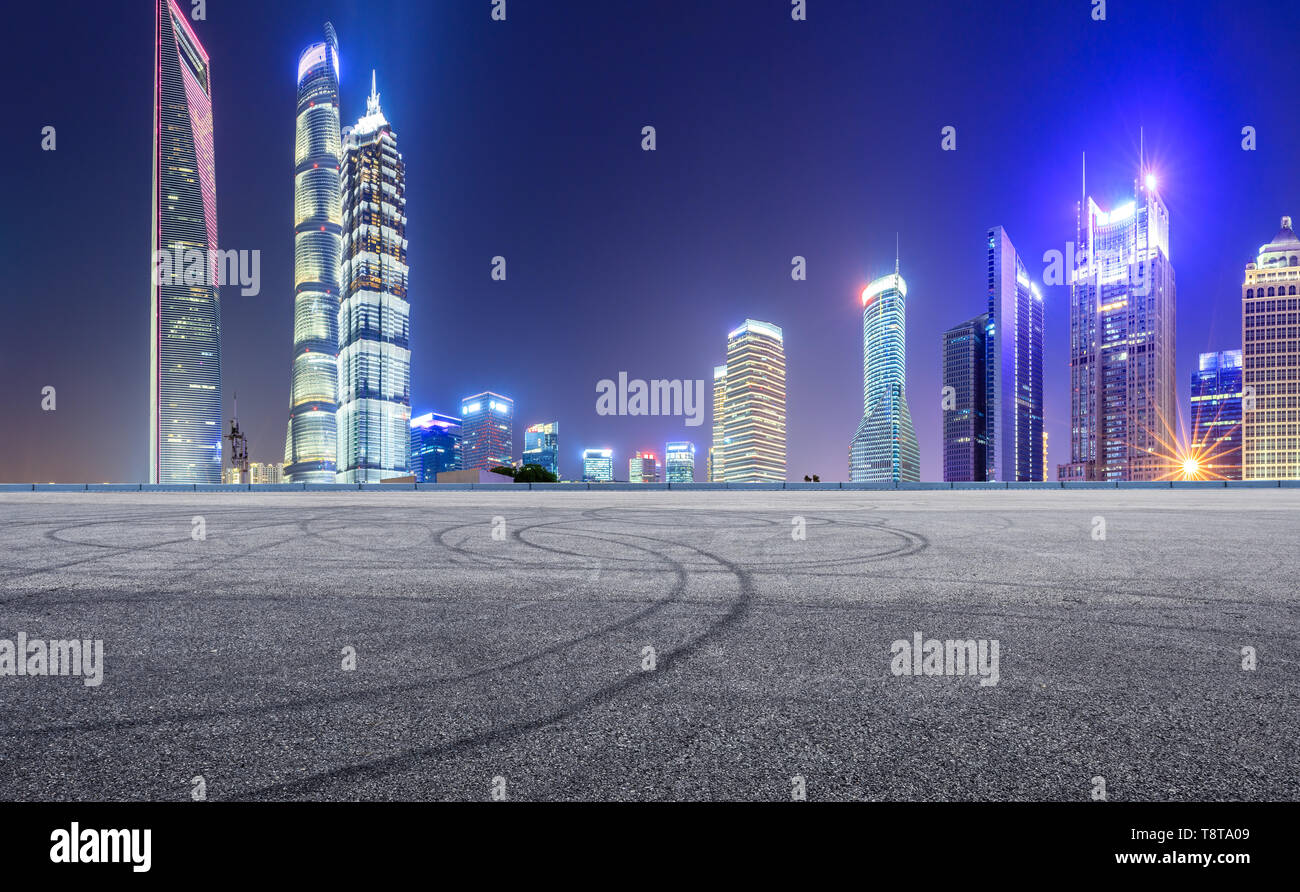 Asphalt race track and modern skyline and buildings in Shanghai at night,panoramic view Stock Photo