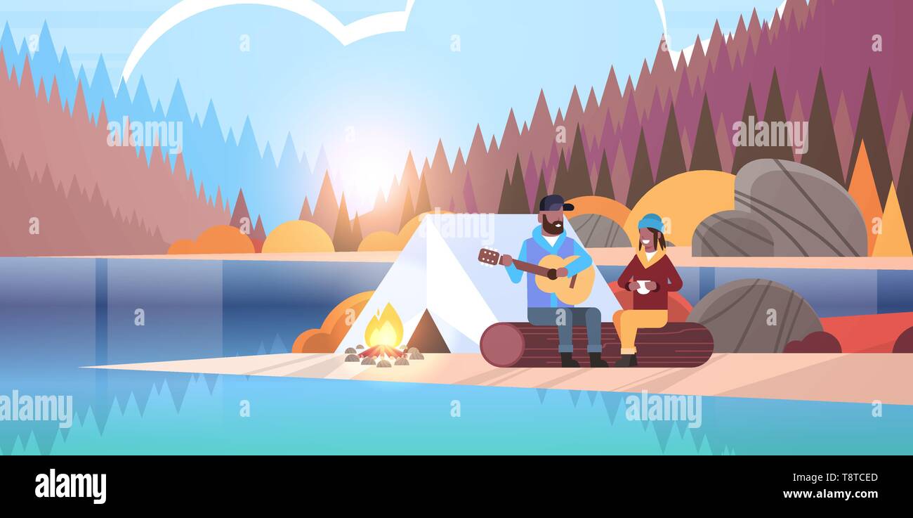 couple tourists hikers relaxing in camp african man playing guitar for girlfriend sitting on log hiking concept sunrise autumn landscape nature river Stock Vector