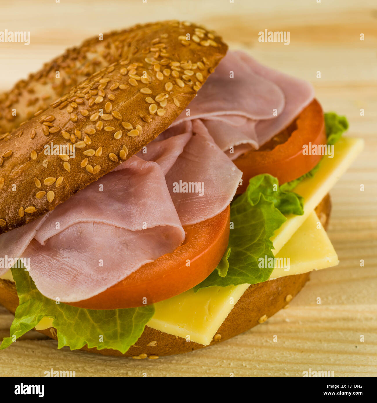 A Fresh Ham Cheese and Salad Toasted Bagel Stock Photo