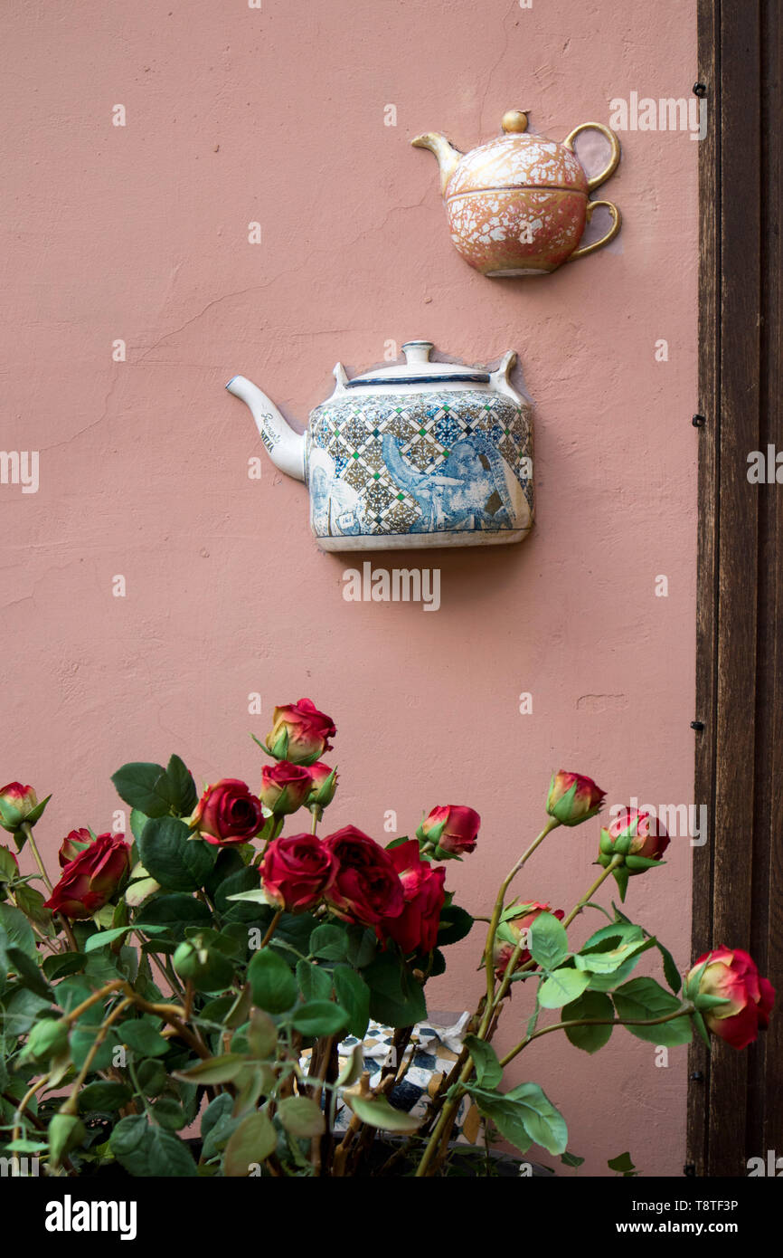 half ceramic teapots glued on the wall of a house in Vilnius Stock Photo