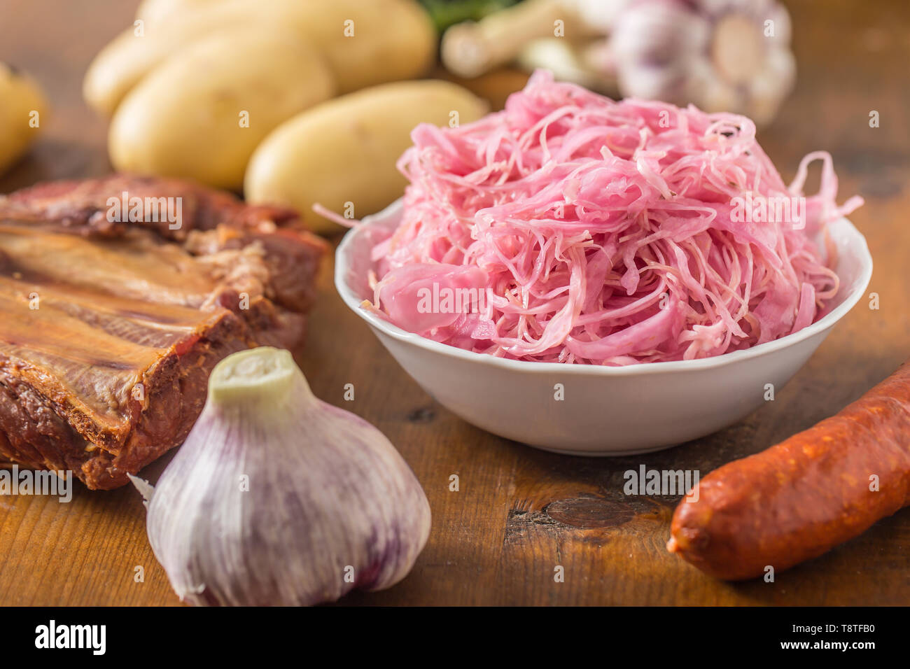 Sour cabbage with smoked ribs sausages potatoes and garlic Stock Photo