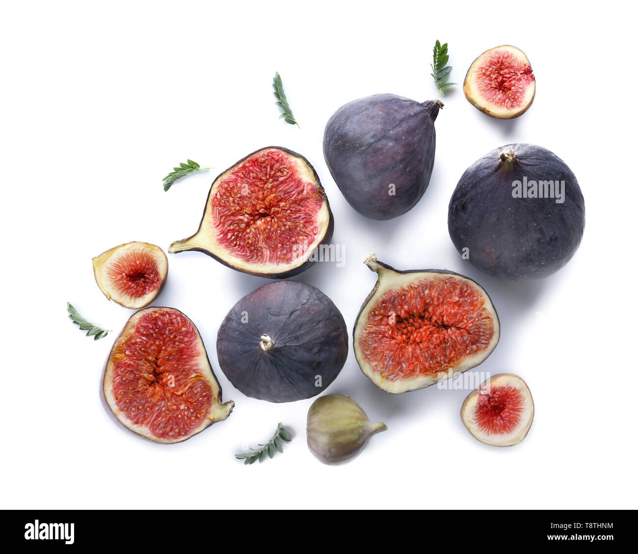 Whole and cut ripe figs on white background Stock Photo - Alamy