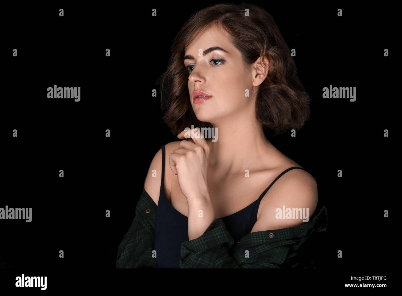 Portrait of beautiful young woman on dark background Stock Photo - Alamy