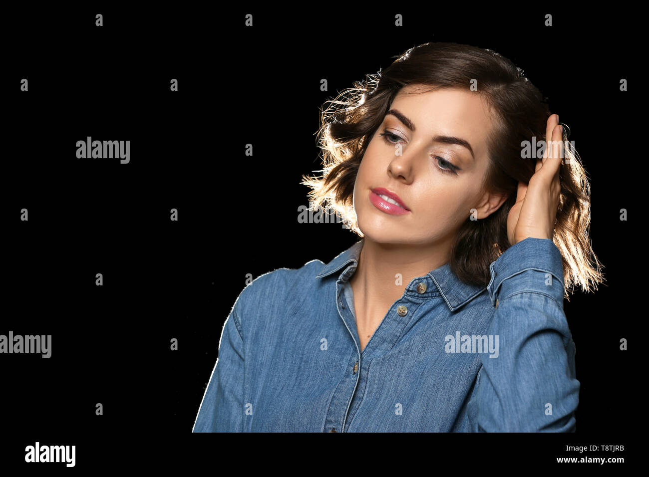 Portrait of beautiful young woman on dark background Stock Photo - Alamy