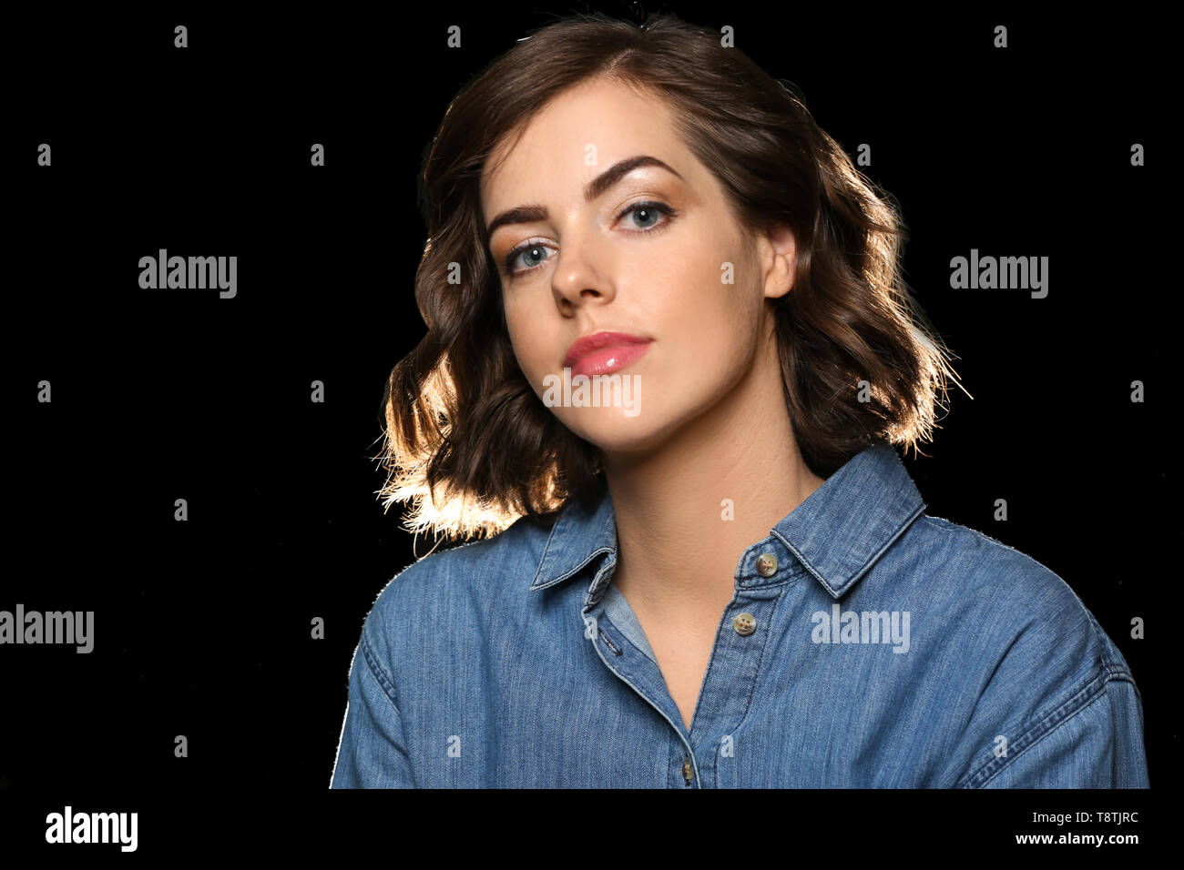 Portrait of beautiful young woman on dark background Stock Photo - Alamy