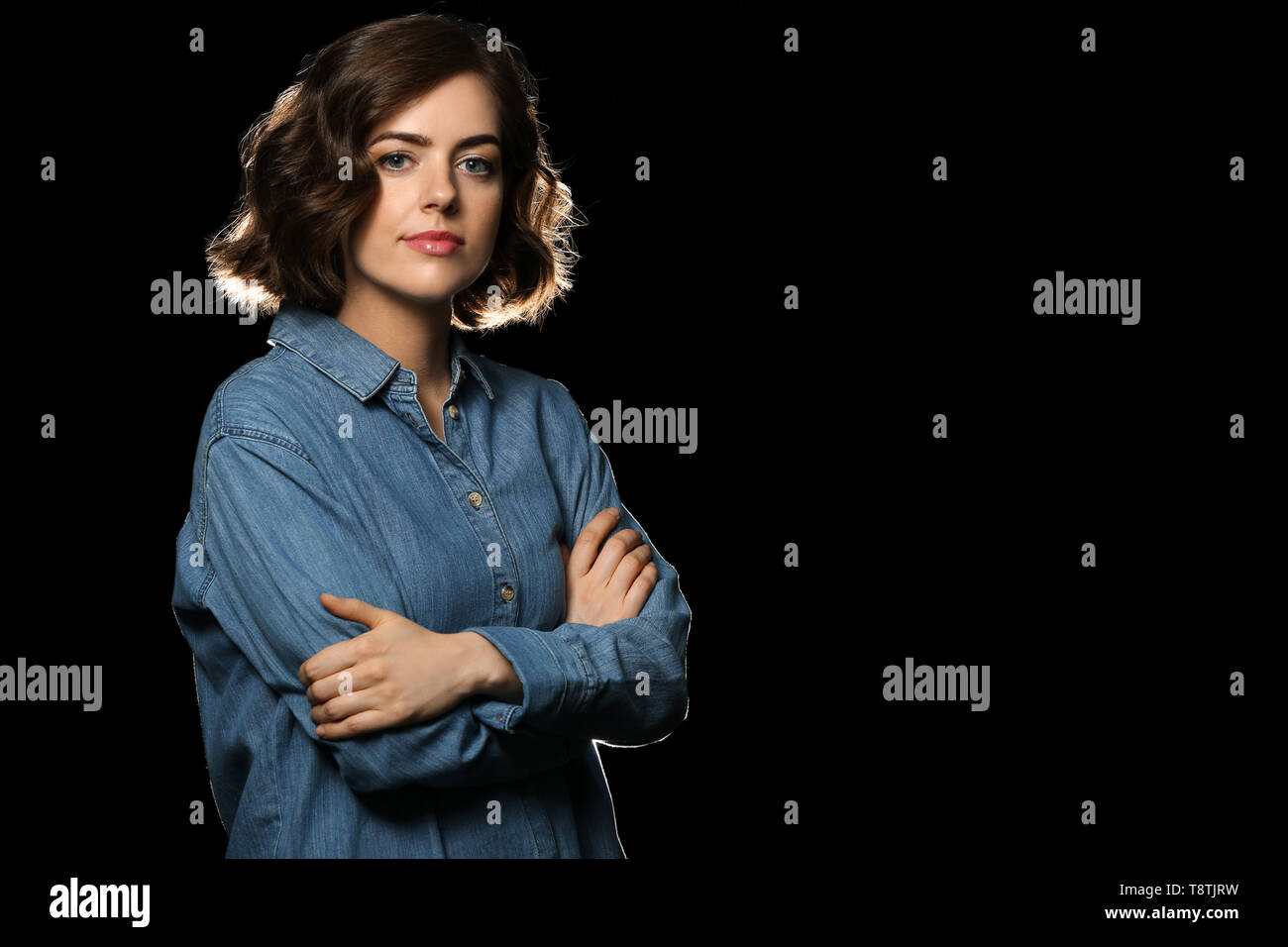 Portrait of beautiful young woman on dark background Stock Photo - Alamy