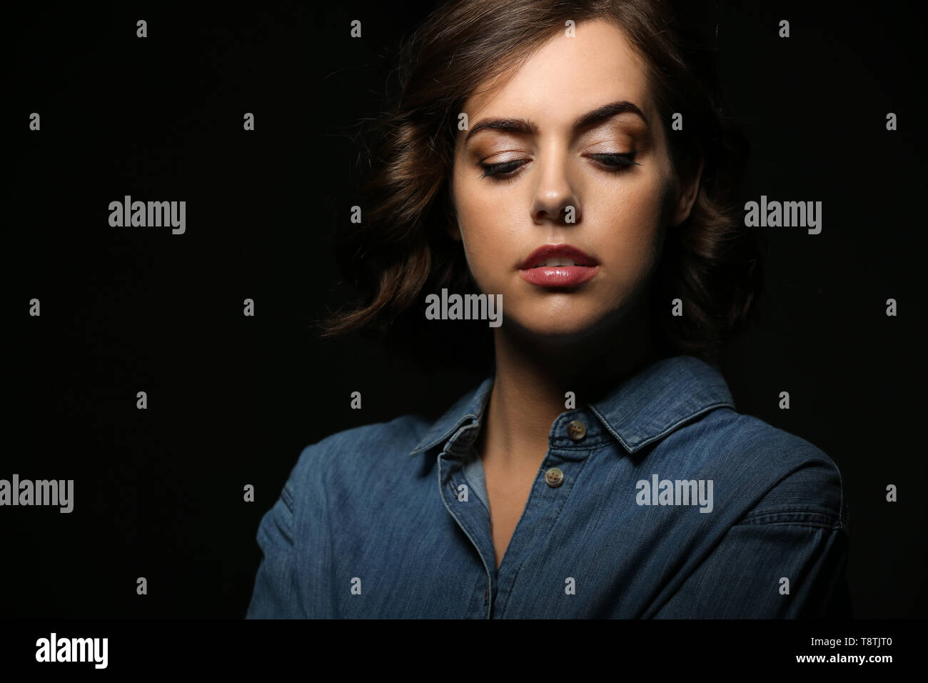 Portrait of beautiful young woman on dark background Stock Photo - Alamy
