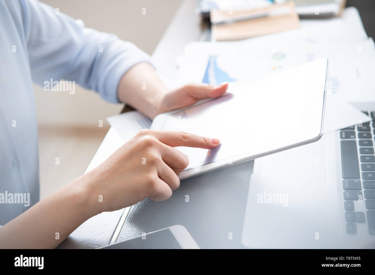 Business concept. Woman using tablet for project with digital device in office desk