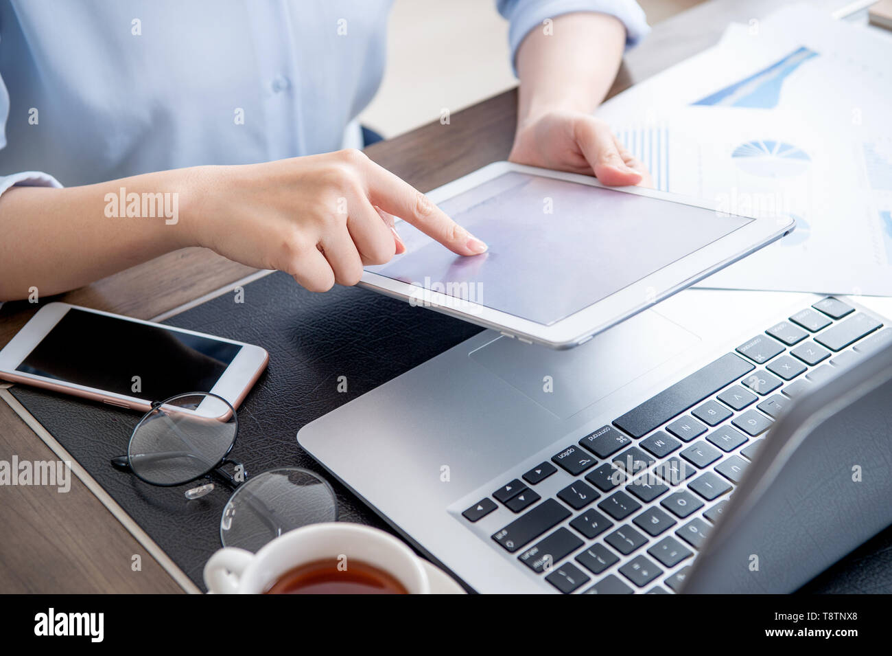 Business concept. Woman using tablet for project with digital device in office desk