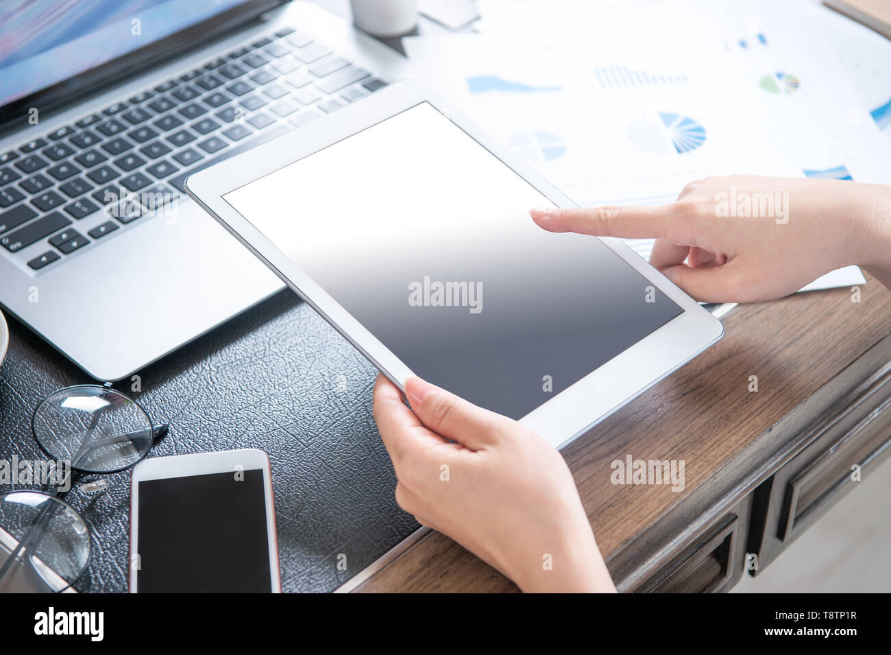 Business concept. Woman using tablet for project with digital device in office desk