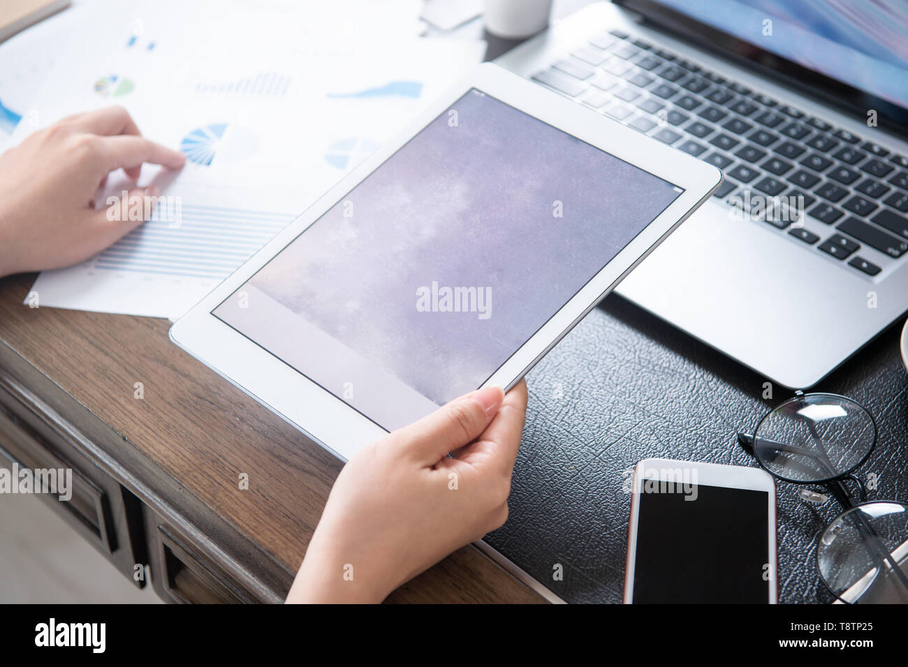 Business concept. Woman using tablet for project with digital device in office desk