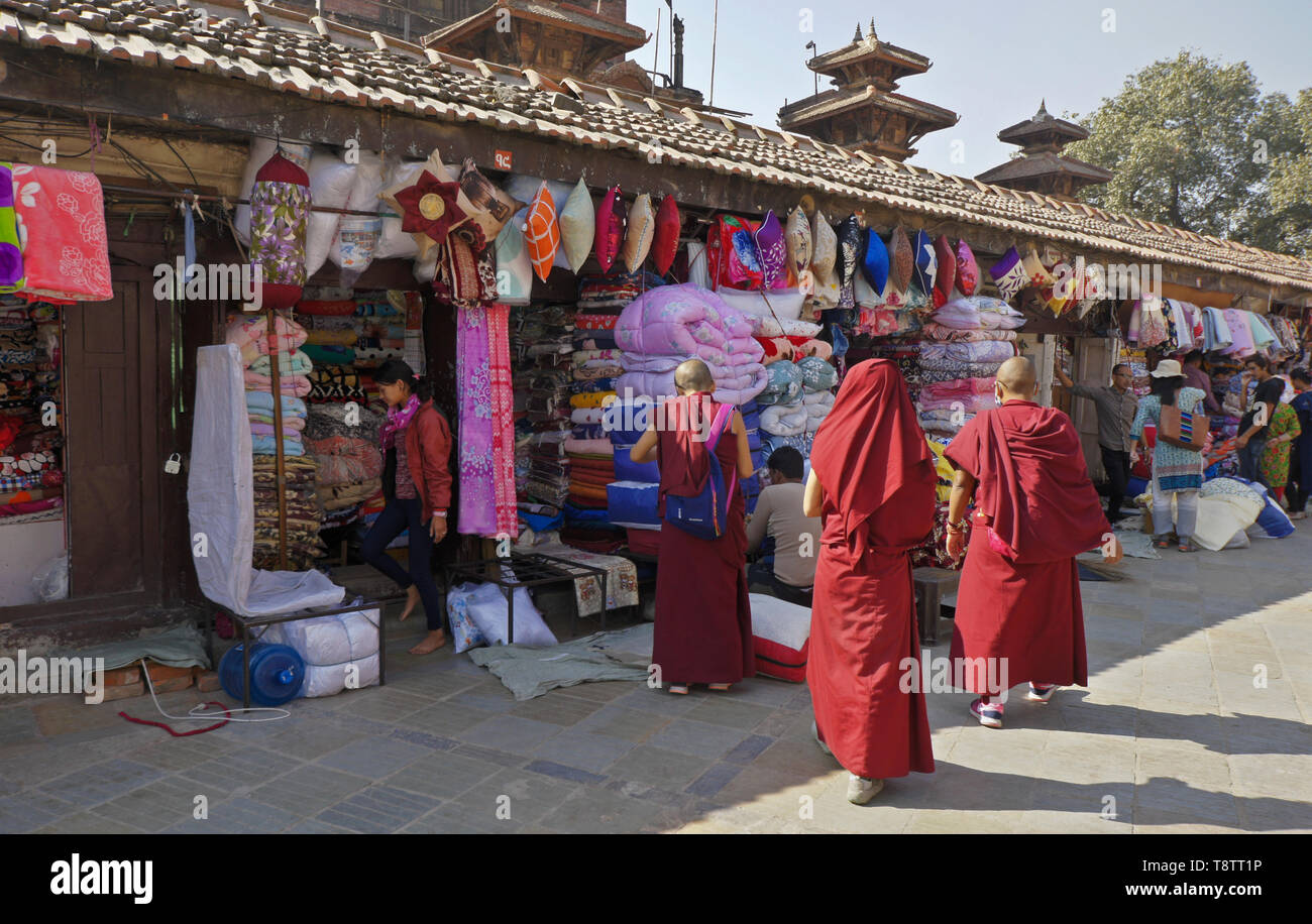 Buddhist monks in red robes shopping in market near Durbar Square, Kathmandu, Nepal Stock Photo