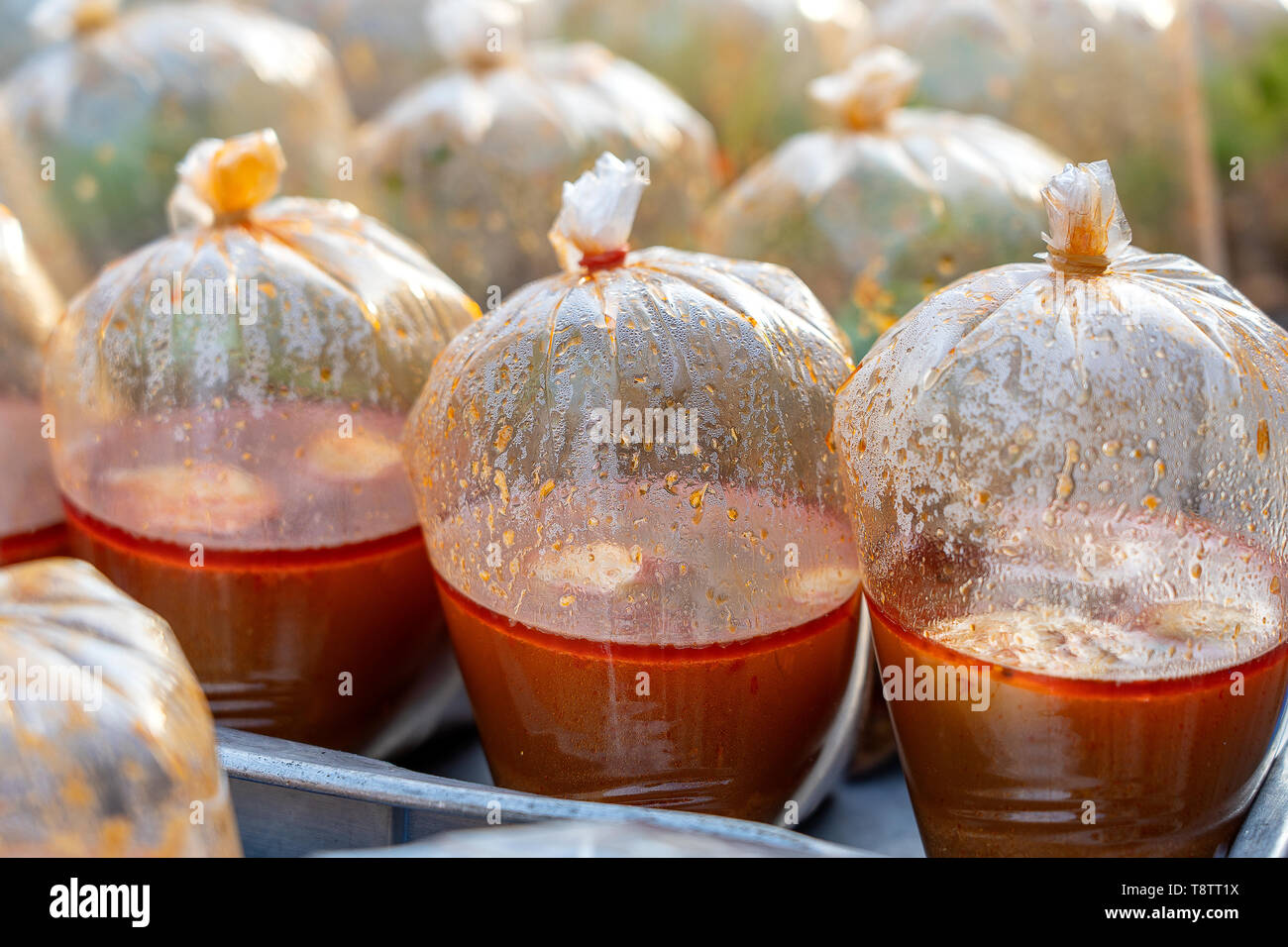 Traditional Thai soup and curry in plastic bags in a metal tray at a street  market, close up, Thailand. Thai street food in plastic bag, thai cuisine  Stock Photo - Alamy