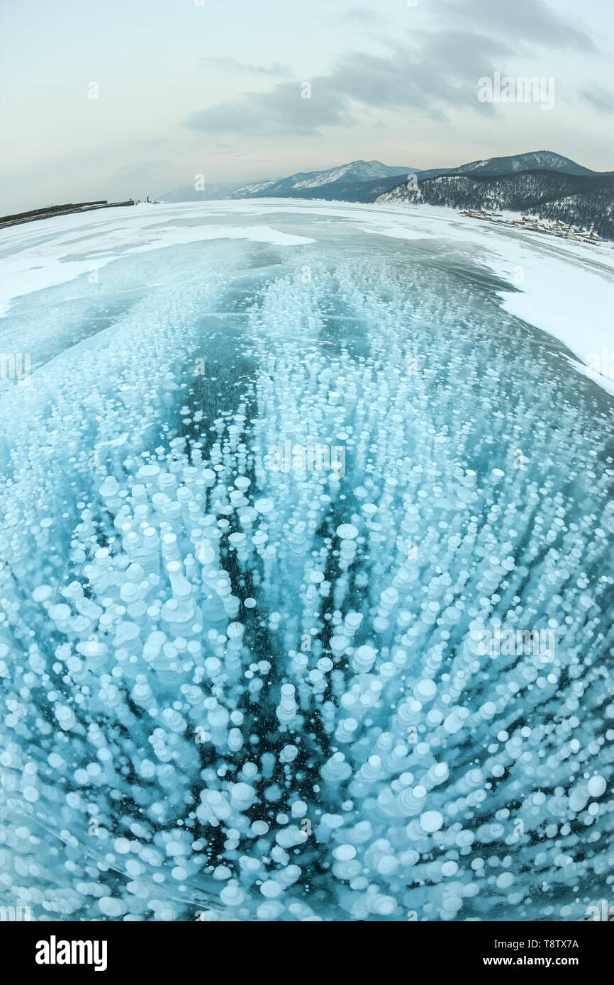 Bubbles of methane gas frozen into clear ice lake baikal, russia Stock