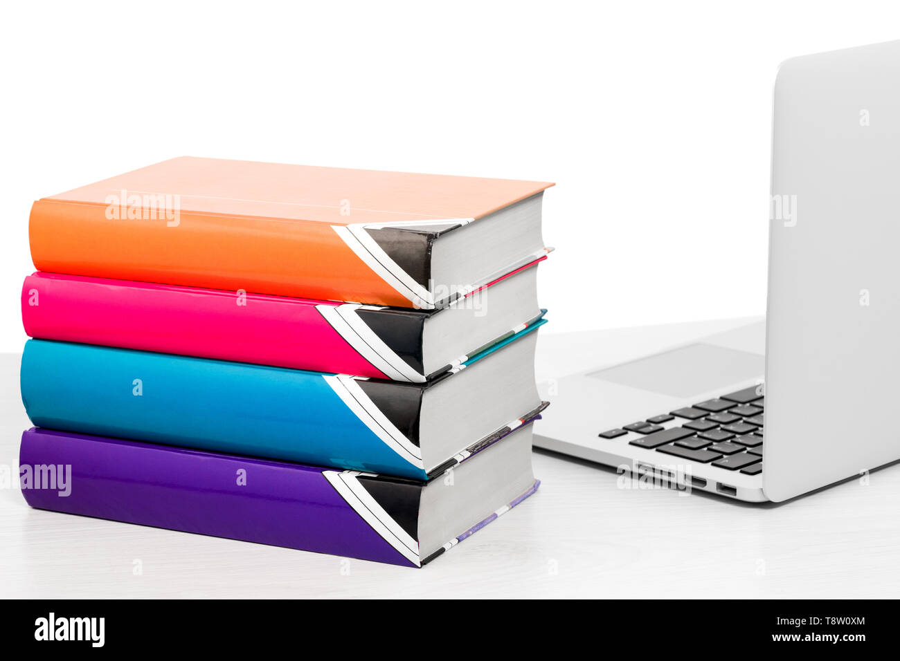 Computer and books on table on white background, isolated Stock Photo