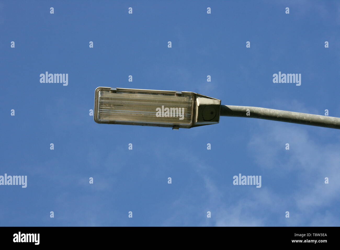 A rectangular street lamp, blue sky in the background Stock Photo