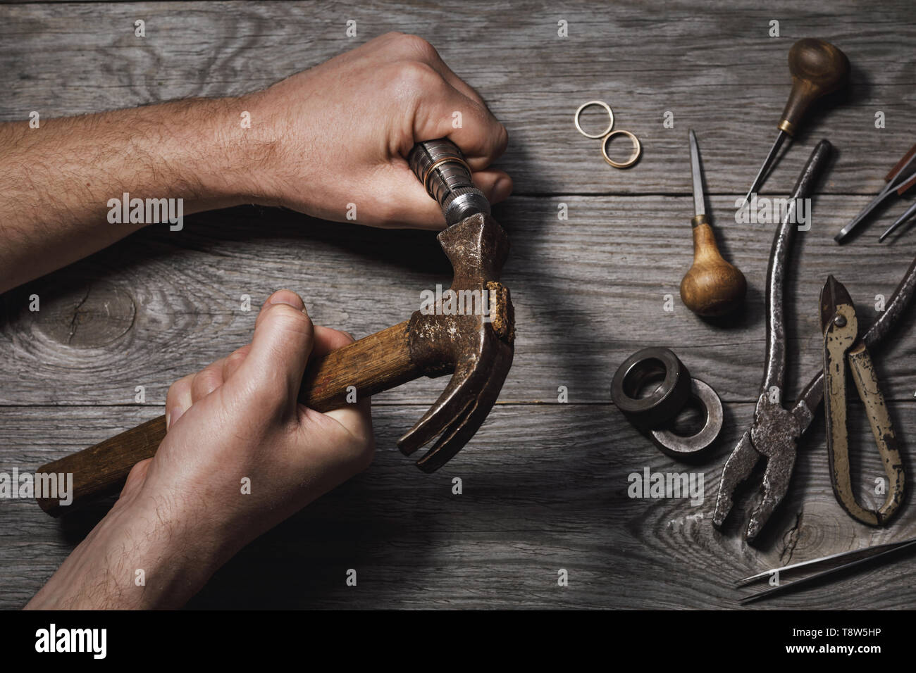 Workflow of increasing the gold ring in the jewelry workshop on the background of tools Stock Photo