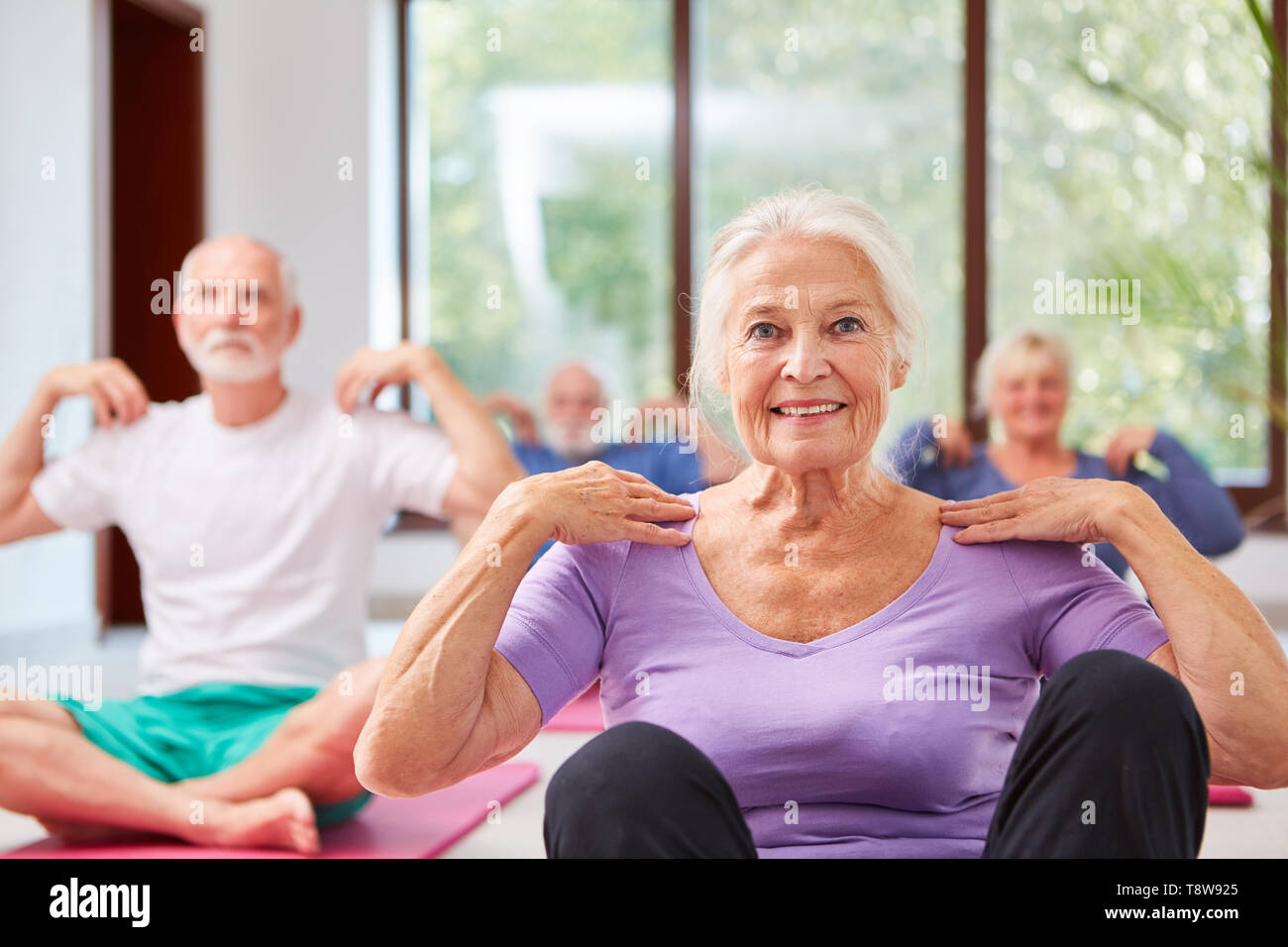 Group of seniors in a rehab course doing physical exercise exercise