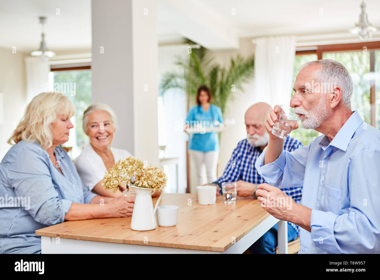 Senior citizens in the old people's home are waiting for medication or taking medicine Stock Photo